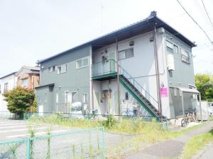 a gray building with a staircase on the side of it at Harbor City Terrace 202 - Vacation STAY 13565 in Higashi-horidōri
