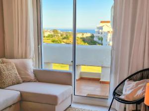 a living room with a couch and a view of the ocean at Seaview Penthouse Valle Romano Golf in Estepona