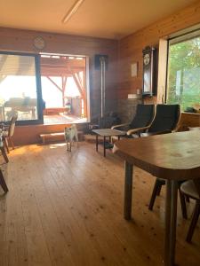 a room with tables and chairs and a dog in it at Takahira Base - Vacation STAY 61542v in Yakushima