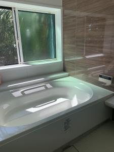 baño con lavabo blanco y ventana en Takahira Base - Vacation STAY 61542v en Yakushima