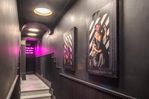 a hallway with paintings on the walls of a building at Palazzetto Trevi in Rome