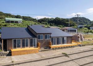 a house with a black roof and windows at Nihonkai Yuhi Villa One Story - Vacation STAY 67117v 