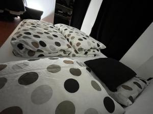a bed with polka dots and pillows on it at Schönes Loft mit Kamin in Mitte Gesundbrunnen in Berlin