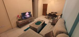 a living room with a couch and a tv at STEFARIS "koutsou court 105" in Larnaca