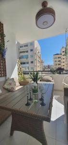 a table with two wine glasses on a balcony at STEFARIS "koutsou court 105" in Larnaca