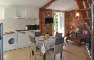 a kitchen and dining room with a table and chairs at 2 Bedroom Beautiful Home In Lolme in Lolme