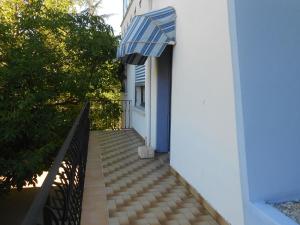 a stairway with a blue and white umbrella on a building at Villa NORICA in Bordezac