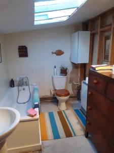 a bathroom being remodeled with a toilet and a sink at Sundial Cottage in Norwich