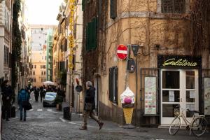 a man walking down a street in a city at Splendido appartamento nel centro di Roma, Monti in Rome