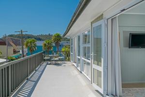 a balcony with a view of the water at Rooftops Accommodation in Whitianga