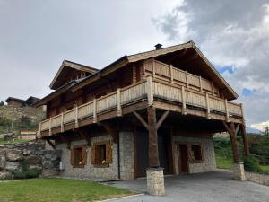 a large wooden house with a balcony on top at Saint Bernard in Font-Romeu-Odeillo-Via