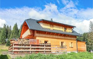a large wooden house with a gambrel roof at 3 Bedroom Nice Home In Flattnitz in Flattnitz