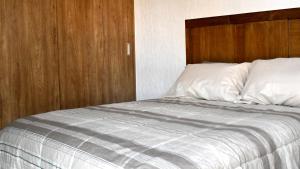 a bedroom with a bed with a wooden headboard at Penthouse junto al mar in Manzanillo +31 photos