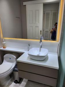 a person taking a picture of a bathroom with a sink at Hermoso Apto en el corazón de la ciudad amurallada in Cartagena de Indias