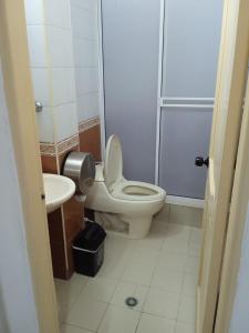 a bathroom with a toilet and a sink at Hotel Caribe Real Inn in Santa Marta