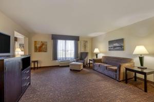 a living room with a couch and a tv at Best Western Plus Omaha Airport Inn in Carter Lake