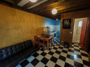 ein Zimmer mit einem Sofa und einem Tisch sowie einer Küche in der Unterkunft Kapai Departamentos de Turismo in Valdivia
