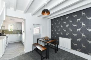 a kitchen with a table and a wall with animals on it at Newark Central Cottage in Newark upon Trent
