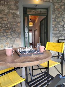 a table with a chess board on top of it at 1935 home in Lílaia