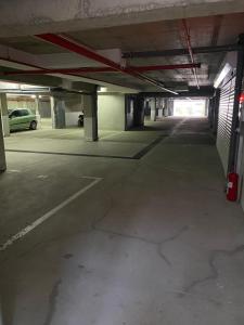 an empty parking garage with a car parked in it at Brzece Apartman 23 in Mramor