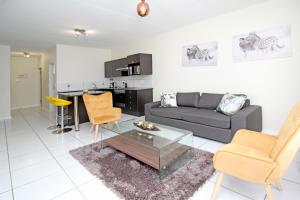 a living room with a couch and a table and chairs at GREENWICH 2 bedroom 2 bath serv apart with 24hrs electricity in Sandton