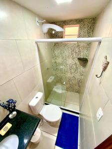 a bathroom with a shower and a toilet and a sink at Casa Porto 14 in Porto De Galinhas