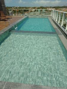 a swimming pool with clear water on a building at Apartamentos praia dos Carneiros in Tamandaré