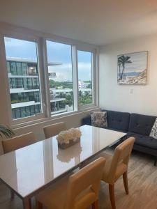 a living room with a table and a couch at Large 1 Bedroom apartment at Roney Palace Sleep 8 in Miami Beach