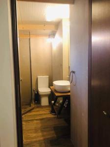 a bathroom with a toilet and a sink at Utopia suites in Egina