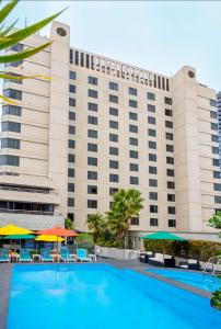 a hotel with a swimming pool in front of a building at Hotel Grand Chancellor Adelaide in Adelaide