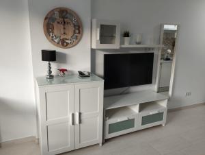 a white entertainment center with a flat screen tv at Estudio Torremolinos Centro by AVA Apartments Wifi y Smart TV in Torremolinos