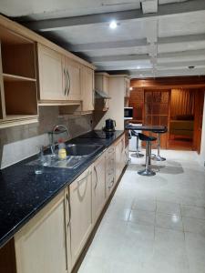 a kitchen with a sink and a counter top at Relevant properties in Welling