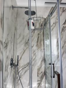 a bathroom with a shower with a glass door at Il Cortile in Enna