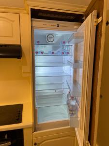 an empty refrigerator with its door open in a kitchen at QDB Hyper Centre Geneve in Geneva