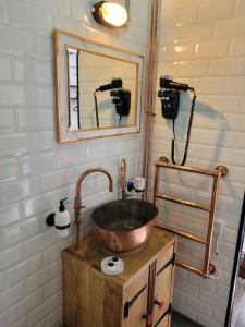 a bathroom with a copper sink and a mirror at The Old Pumping Station, Broseley, Ironbridge Gorge in Broseley