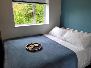 a bowl of food on a bed with a window at The Old Pumping Station, Broseley, Ironbridge Gorge in Broseley