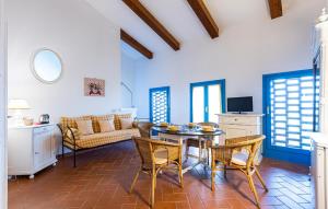a kitchen and living room with a table and chairs at Awesome Apartment In Lazzeretto in Lazzeretto