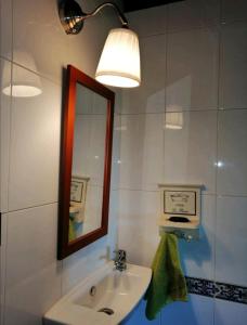 a bathroom with a sink and a mirror at Casa de piedra en pequeña aldea de Ortigueira 