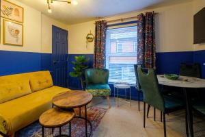 a living room with a yellow couch and a table at Stay in the heart of Isle of Wight in 2BDR apt in Newport