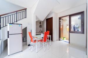 a kitchen and dining room with a table and chairs at Apik Kamila BSD in Tjilandak