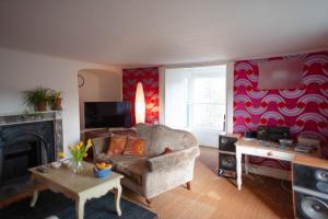 a living room with a couch and a fireplace at The Shire House in Lostwithiel