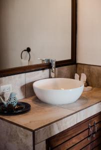 a bathroom with a white bowl sink on a counter at Hotel Los Olivos Santiago Atitlan in Santiago Atitlán