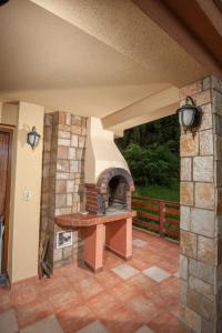 a patio with an outdoor oven in a house at Guest house Lidia in Tsigov Chark