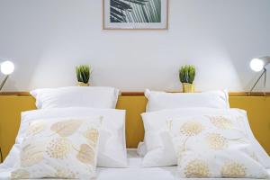two white pillows on a bed with plants on top at Villa Linay in Le Diamant +29 photos