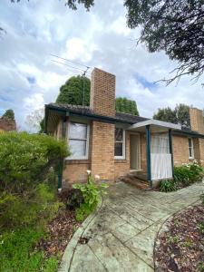 a brick house with a chimney on top of it at Melbourne Mitcham Holiday Home in Mitcham