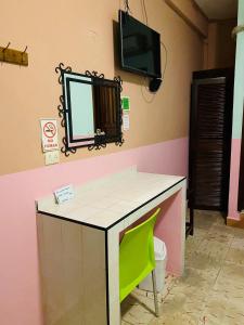 a bathroom with a vanity with a mirror and a tv at Casa Palma Hotel in Playa del Carmen