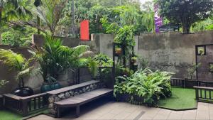 a garden with benches and plants and a wall at Perdana Hills in Petaling Jaya
