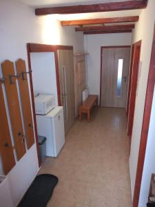 a hallway of a room with a refrigerator and a door at Chalupa Mlyn Dolný Kubín in Dolný Kubín