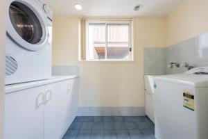 a laundry room with a washer and dryer at 1 6 Convent Lane-LJHooker Yamba in Yamba