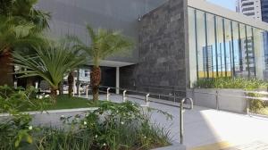 a building with palm trees in front of it at One way in João Pessoa